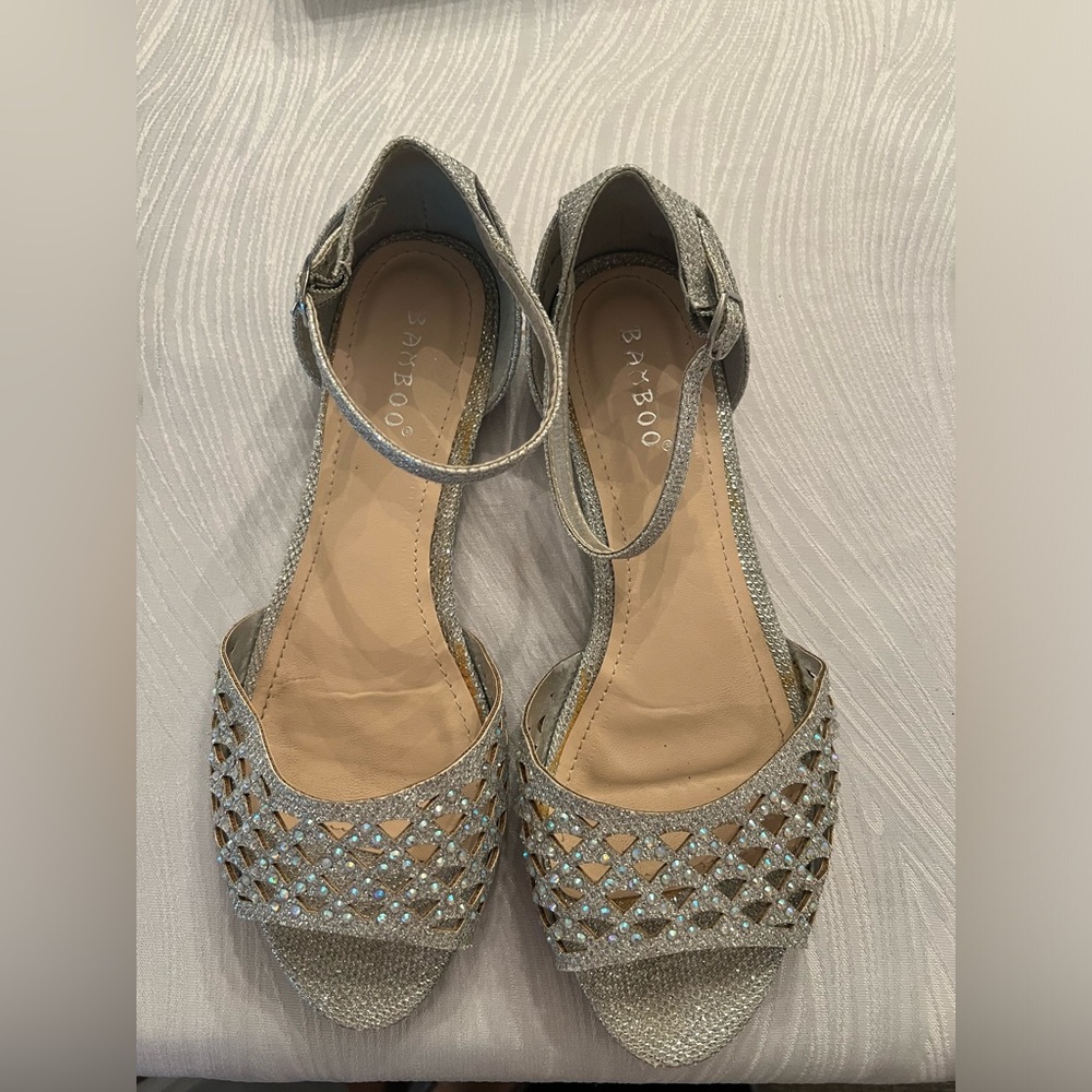 Silver shoes and clutch purse sold as a set.